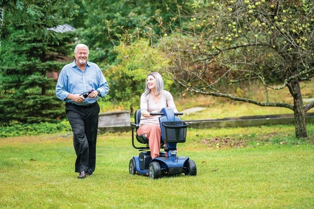 Couple using a mobility scooter outdoors on the San Luis Obispo County coast