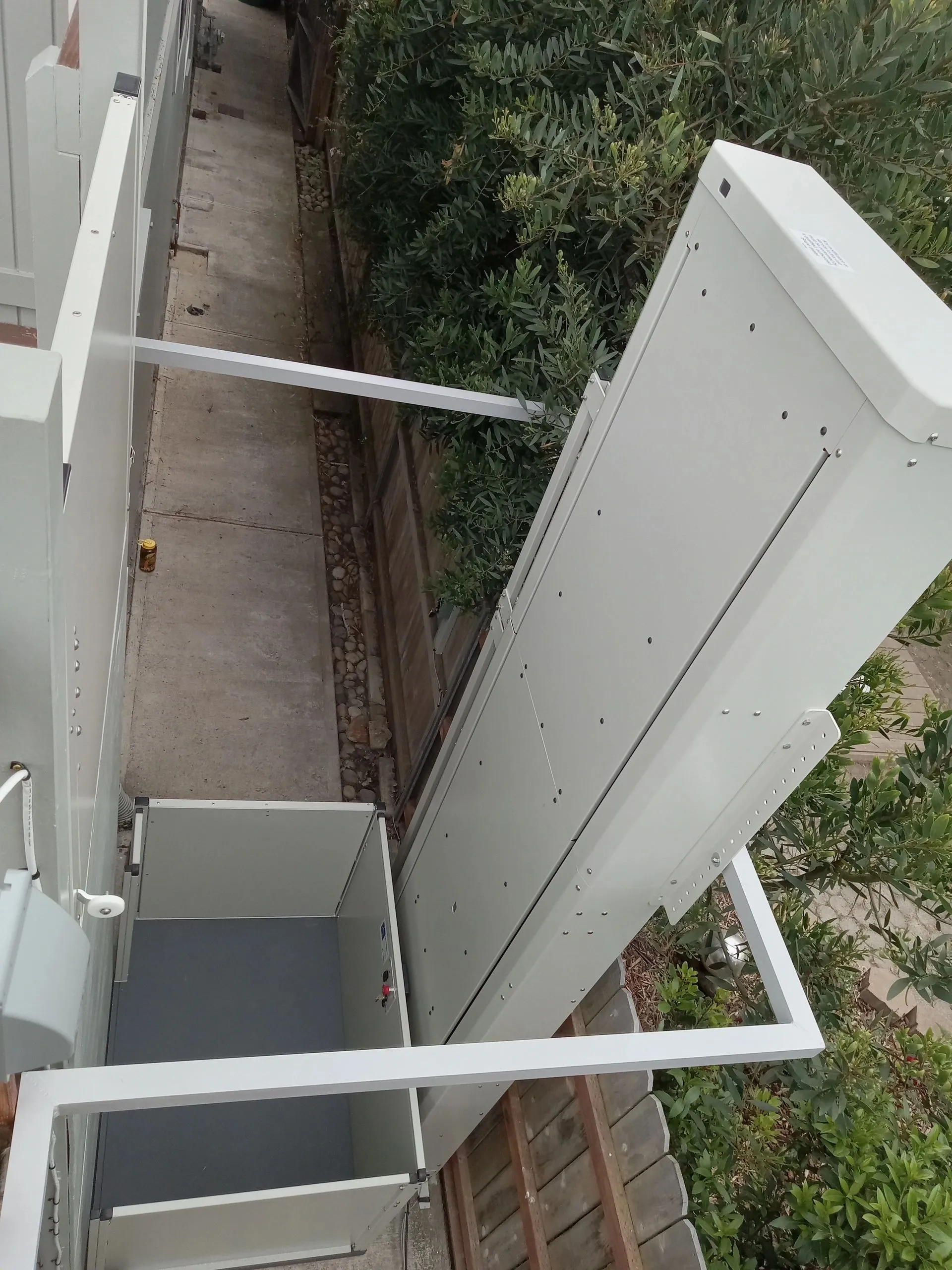 Side view of a platform lift we service in Morro Bay — drive rails and platform mechanism — Essential Mobility