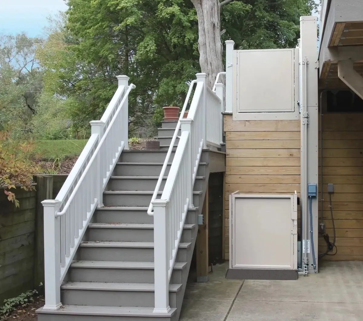 Vertical platform lift installed next to porch stairs in San Luis Obispo County