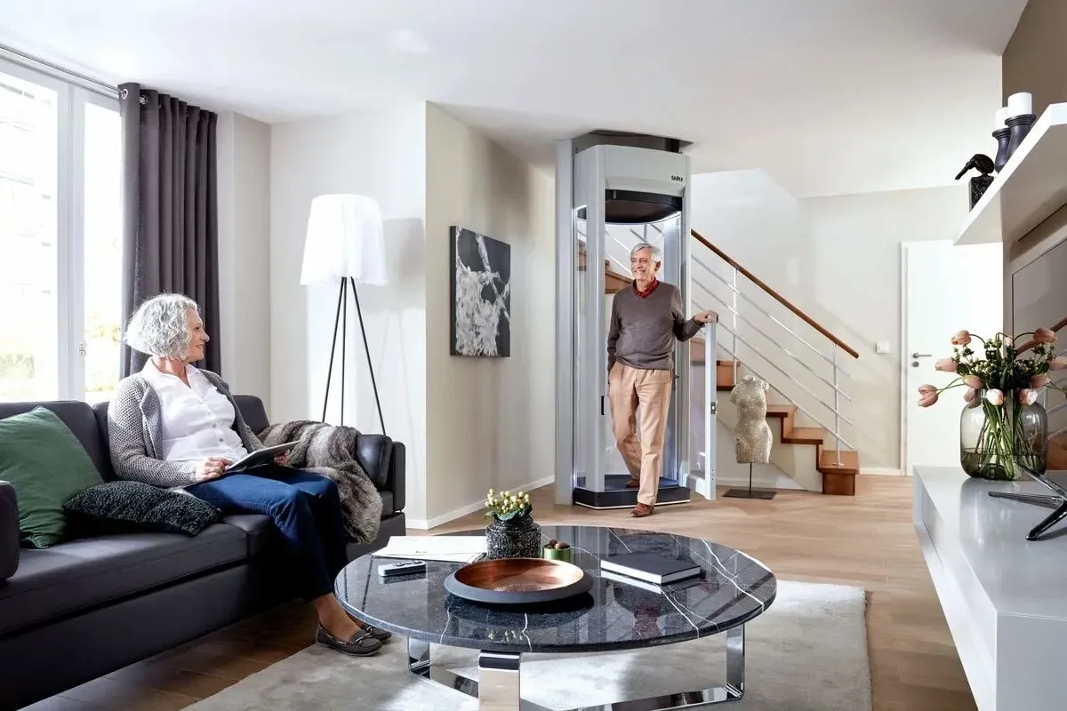Stiltz Duo Alta freestanding home elevator in a San Luis Obispo residence, couple using residential elevator installed by Essential Mobility